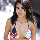 Sexy teen Rachel poses by the creek in a tiny string bikini
